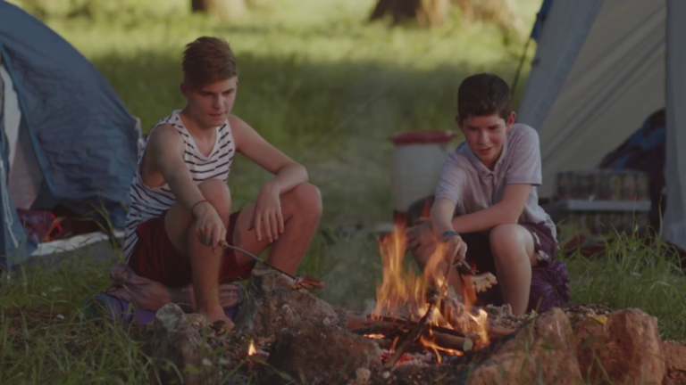 2 boys at the campfire