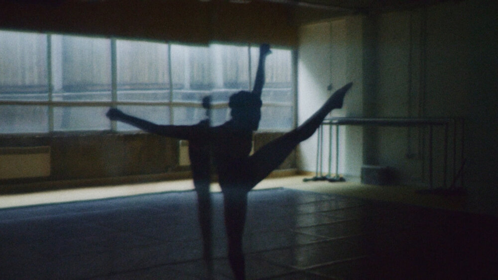 Silhouette of a dancer in the reflection of a mirror