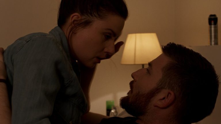 Woman and man looking at each other in the bed