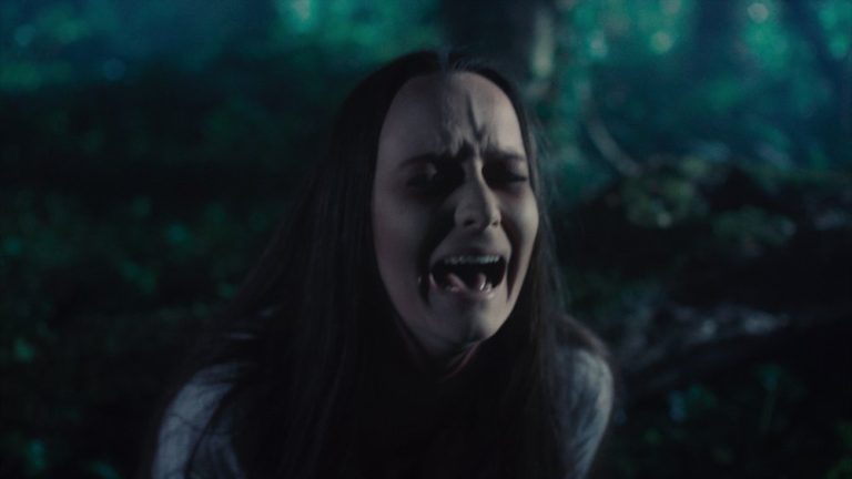 Woman is crying in the forest during the night