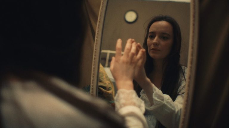Woman looking at herself in the mirror