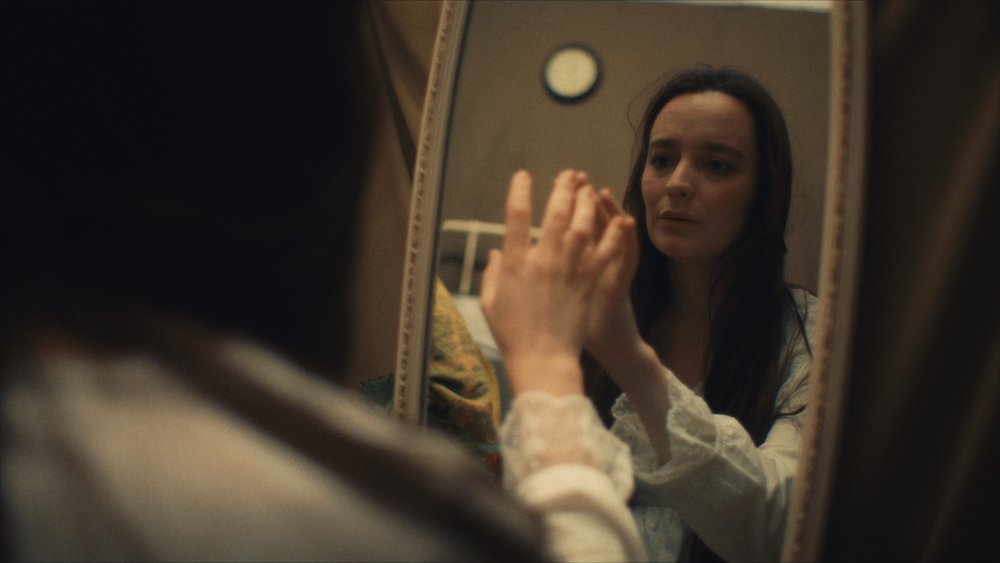 Woman looking at herself in the mirror