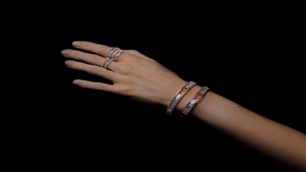 Woman's hand in the water wearing jewelleries