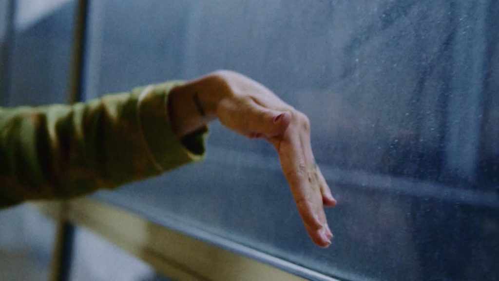 Woman's hand against the window.